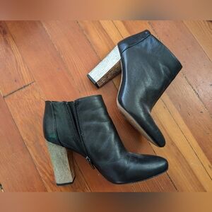 Black leather heeled boots with gold heel